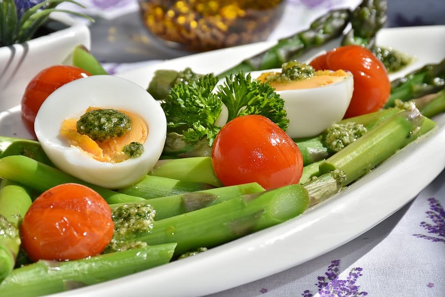 Healthy dinner plate with asparagus eggs and tomatoes